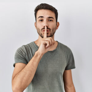 man quiet with finger on lips